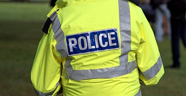 Police officer carrying pepper spray gun for self defense